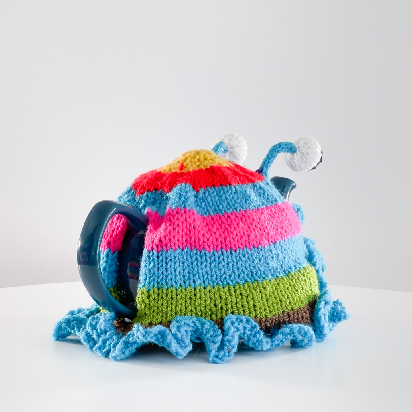 Ruperts house stripy snail tea cosy