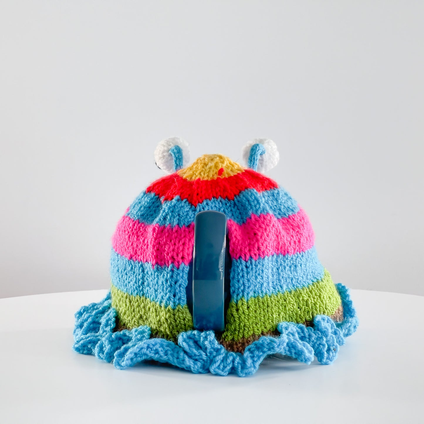 Ruperts house stripy snail tea cosy