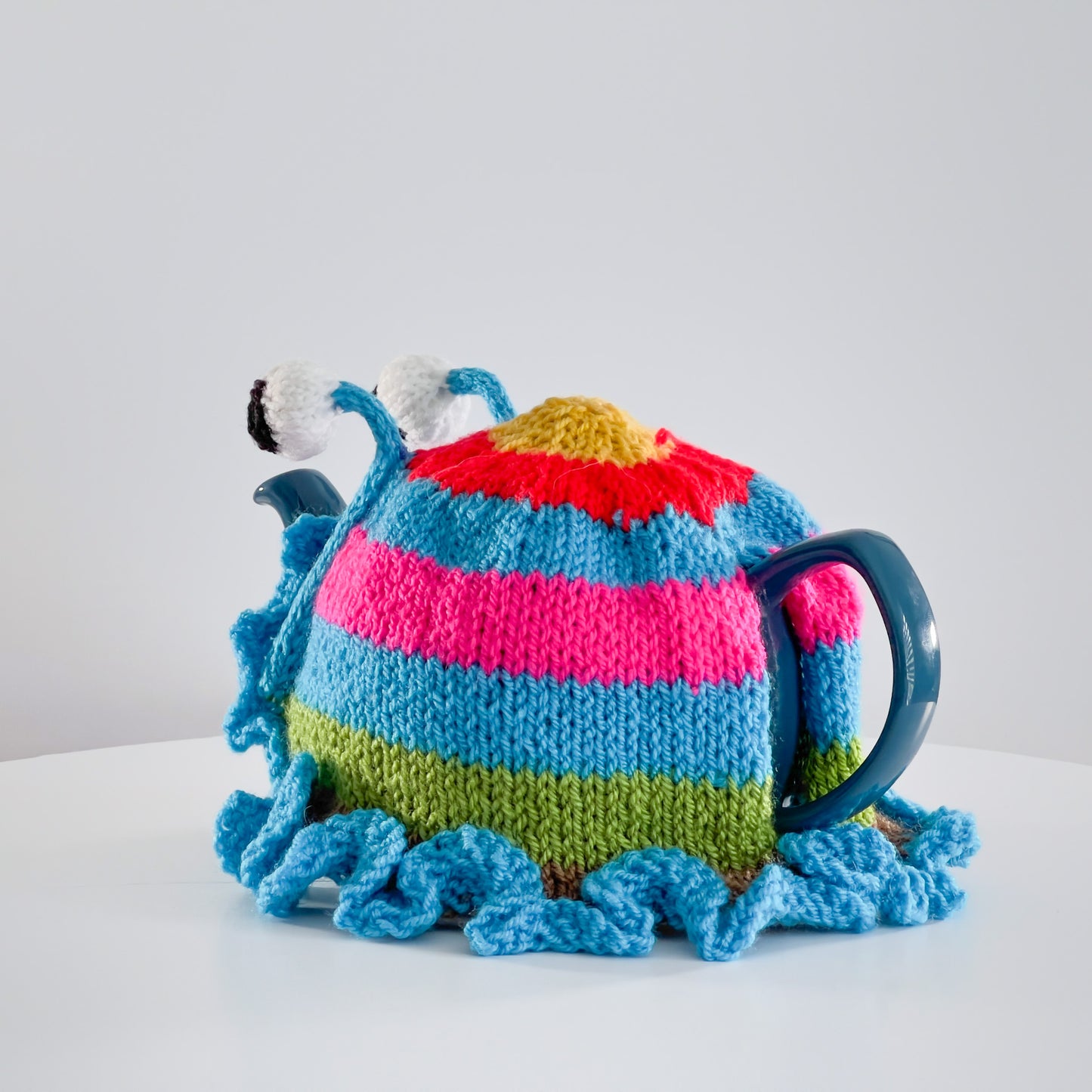 Ruperts house stripy snail tea cosy