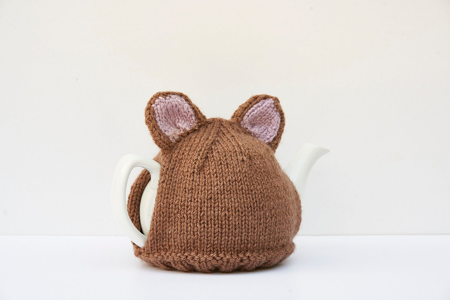 Knitted brown bear tea cosy with pom pom tail. Washable fits 1 litre teapot.