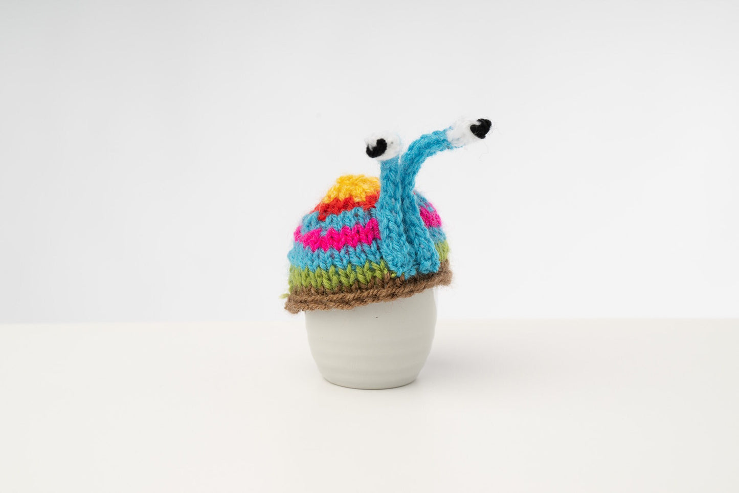 Knitted blue stripy snail tea cosy. Tea lovers teatime treat.