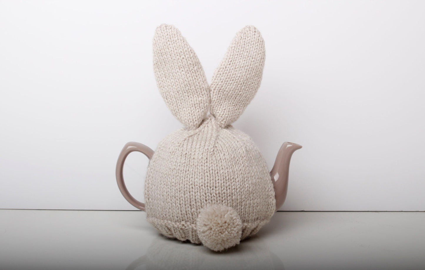 Hand knitted bunny rabbit tea cosy with pom pom bottom. Fits either 6 cup or 2 cup tea pots.