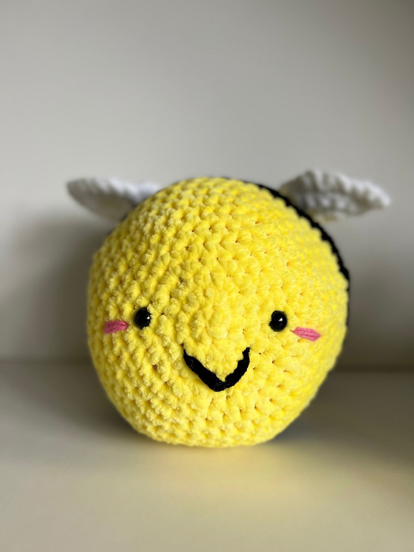 Jumbo the bumble bee - hand crochet super sized chenille cuddle buddy. Available with happy or sad face. Super squishy comforter.