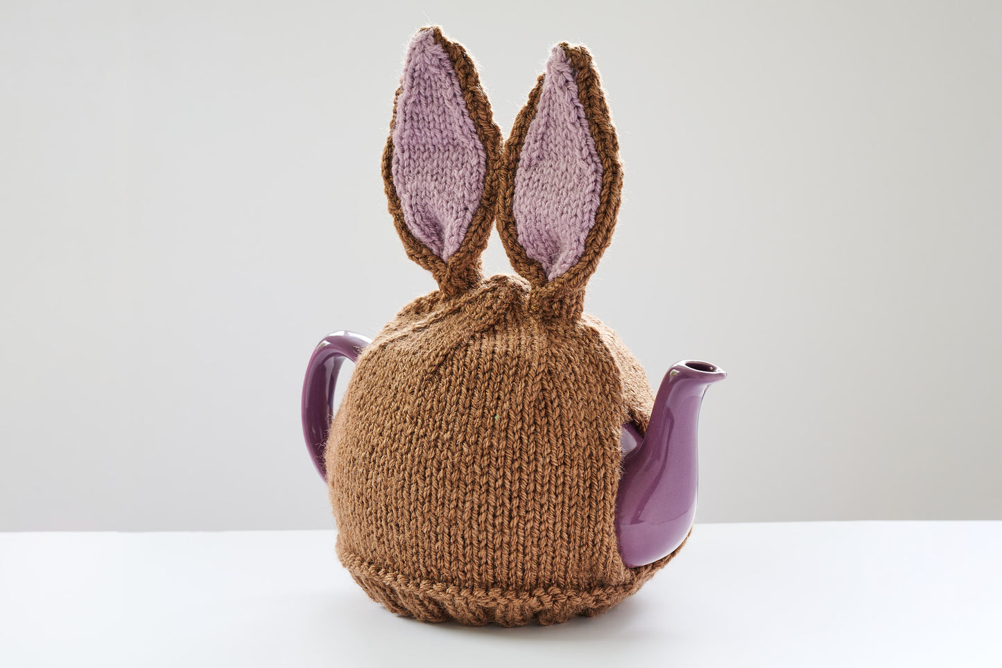 Hand knitted bunny rabbit tea cosy with pom pom bottom.