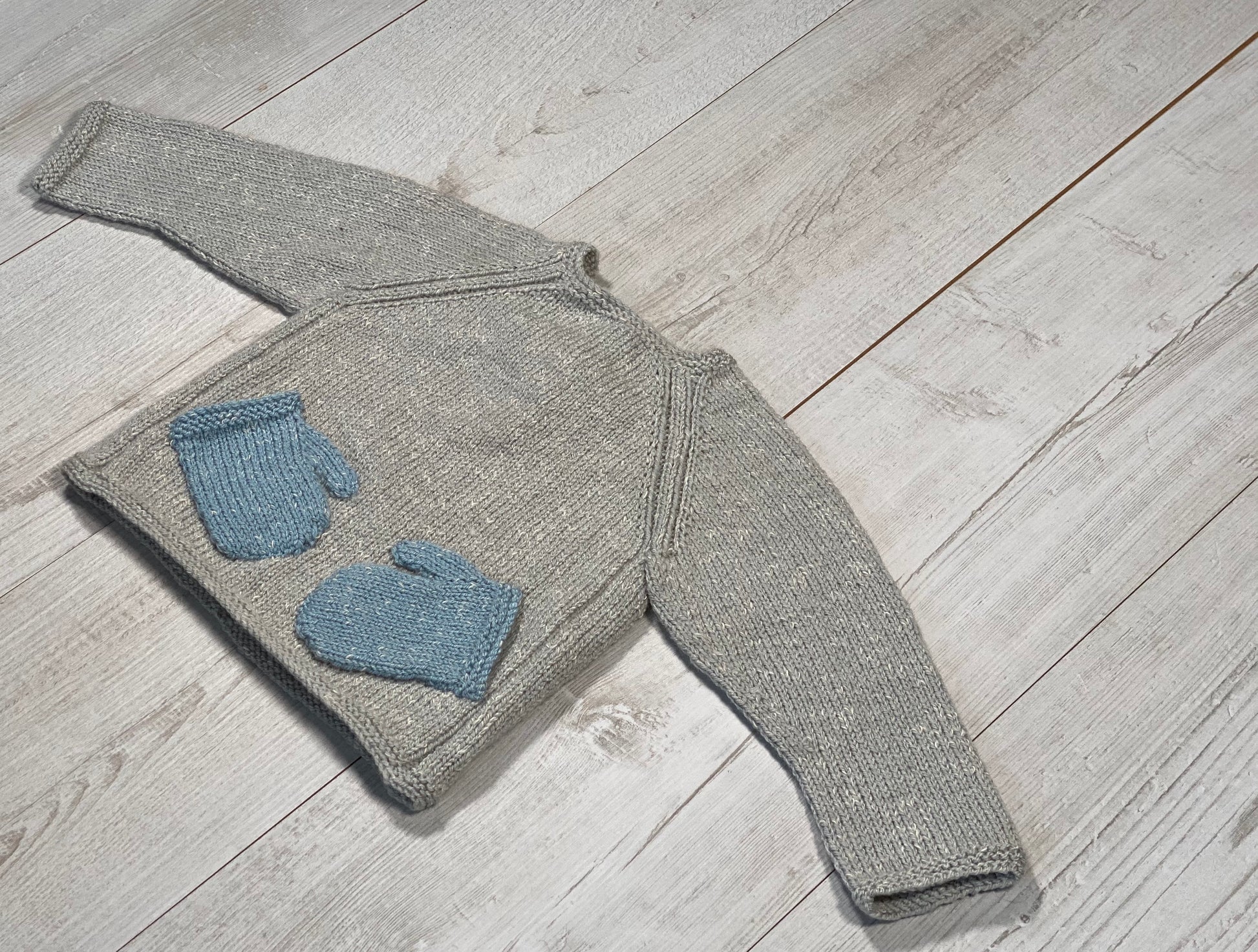 Little knits sweater with mittens on the front by Ruperts House