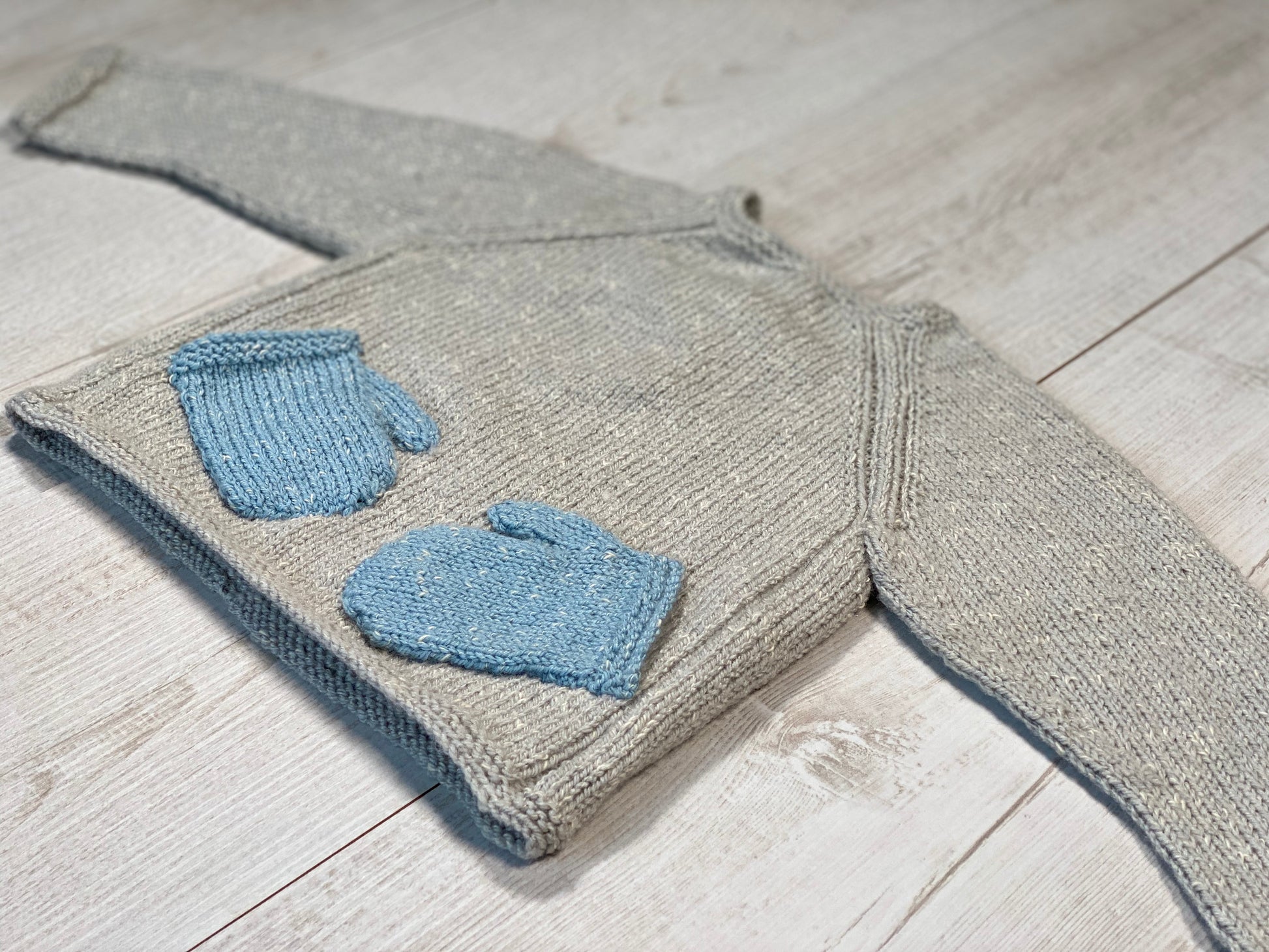 Little knits sweater with mittens on the front by Ruperts House