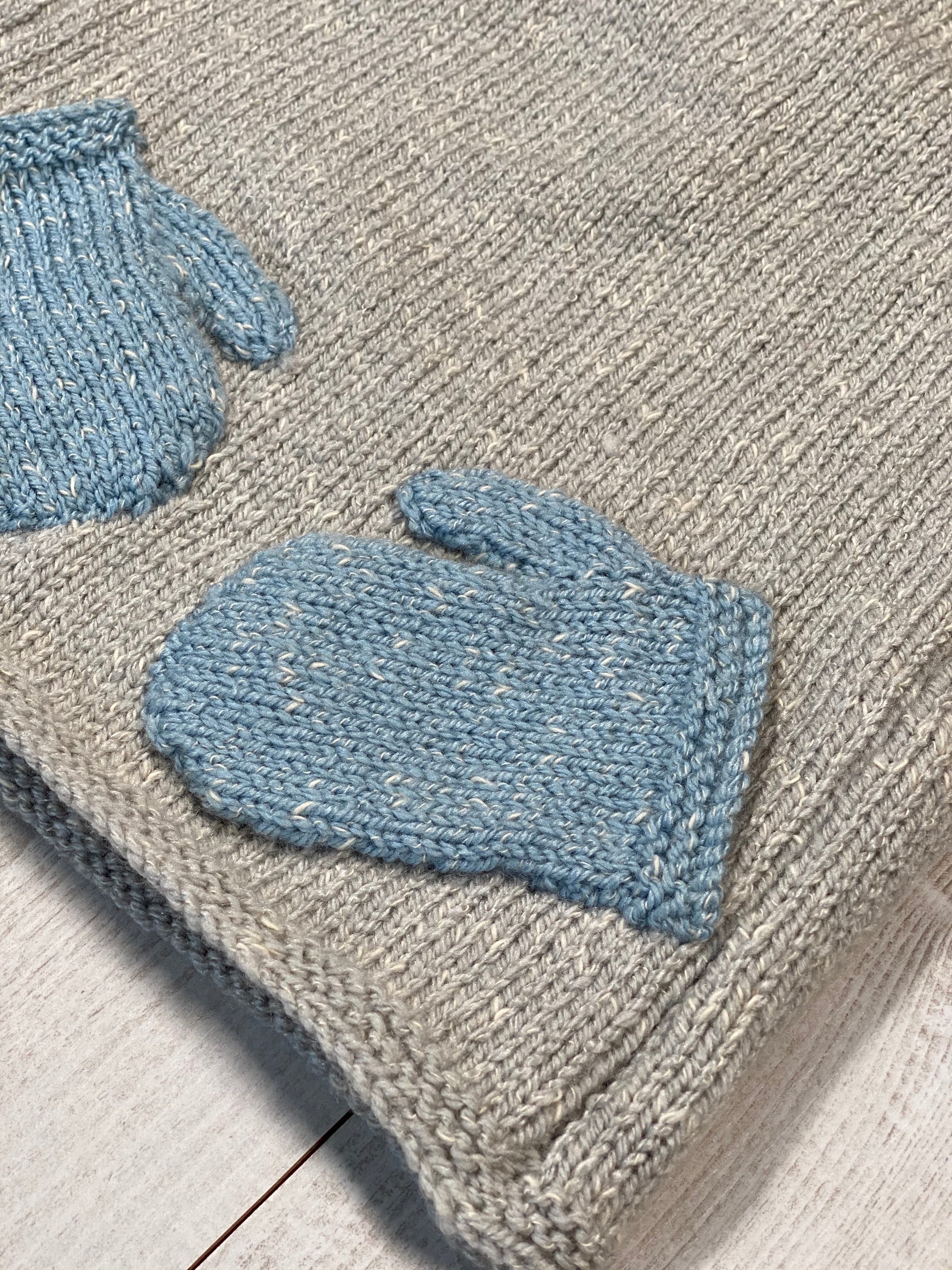 Little knits sweater with mittens attached on the front by Ruperts House