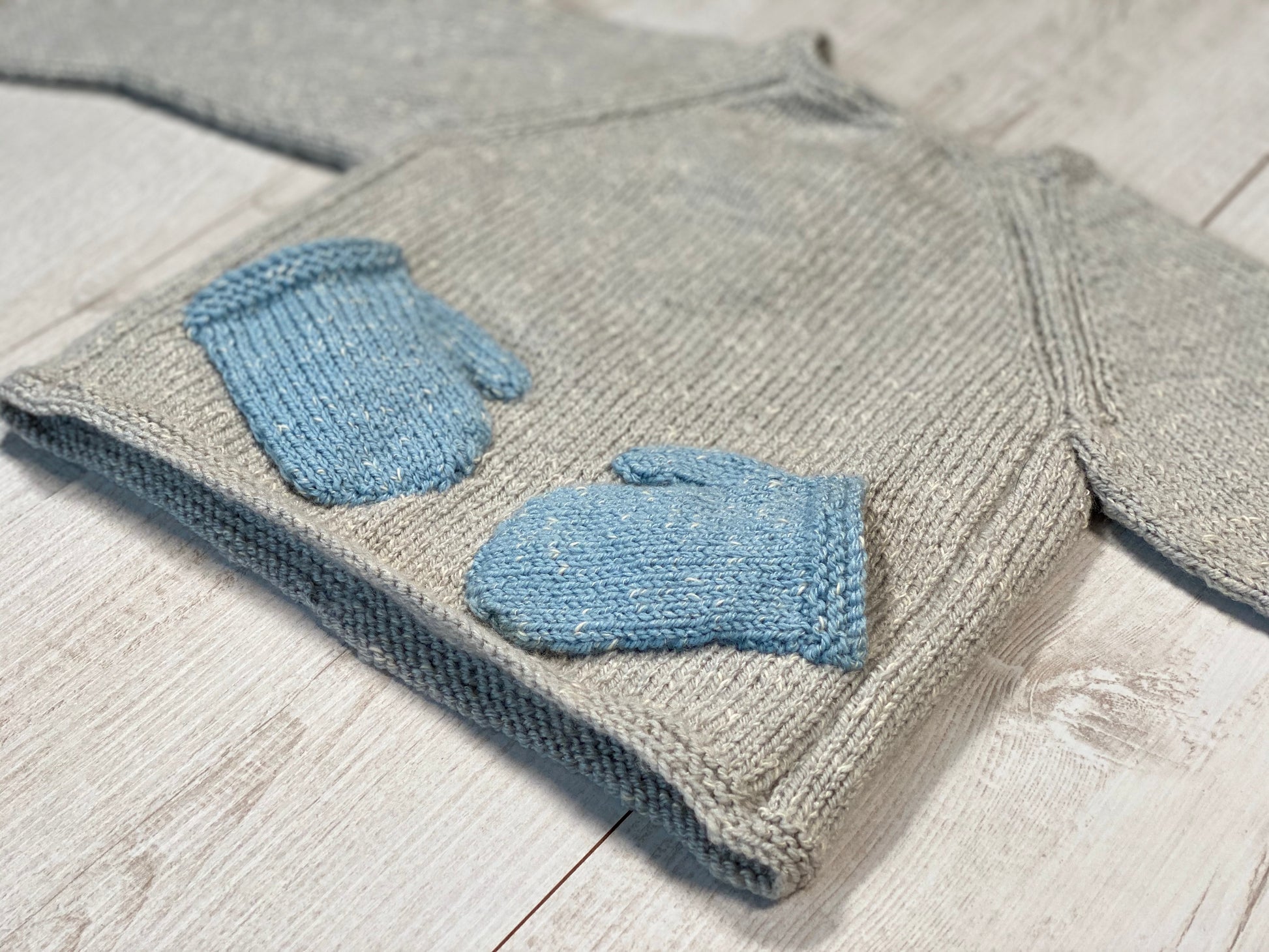Little knits sweater with mittens on the front by Ruperts House