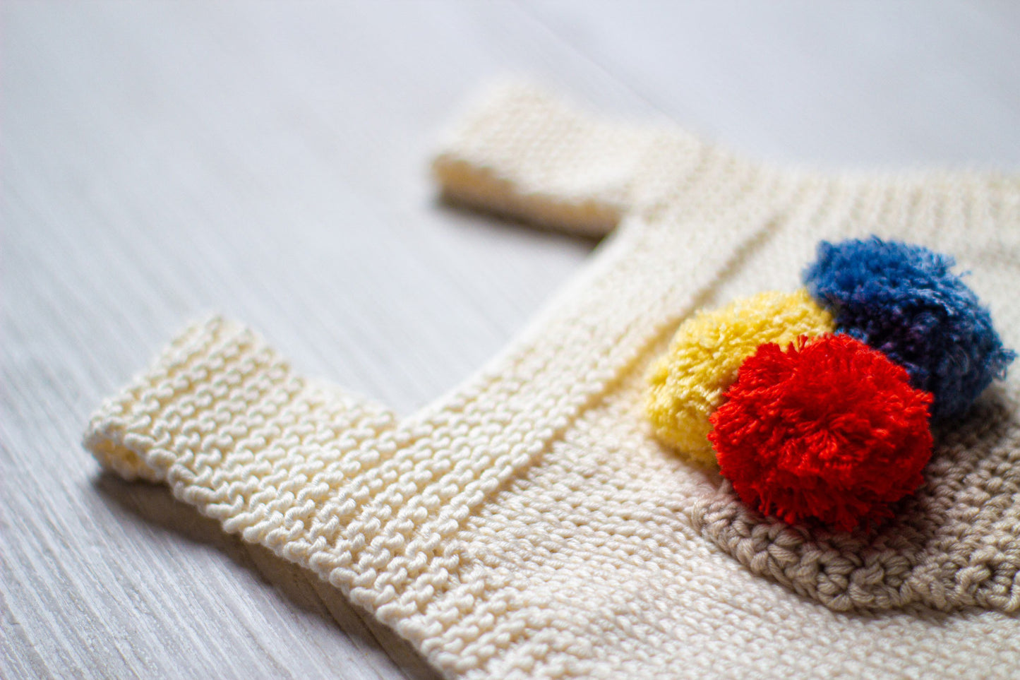 Baby romper hand knitted in cotton with ice cream cone feature 