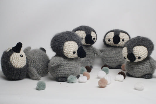 Crocheted penguin toys on a white background