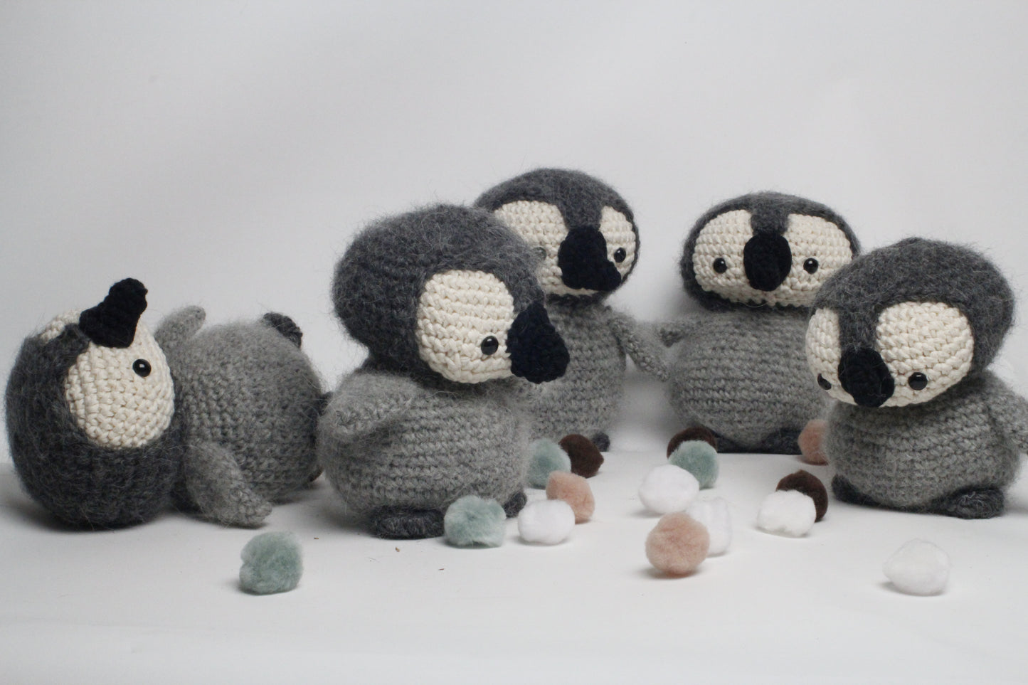 Crocheted penguin toys on a white background