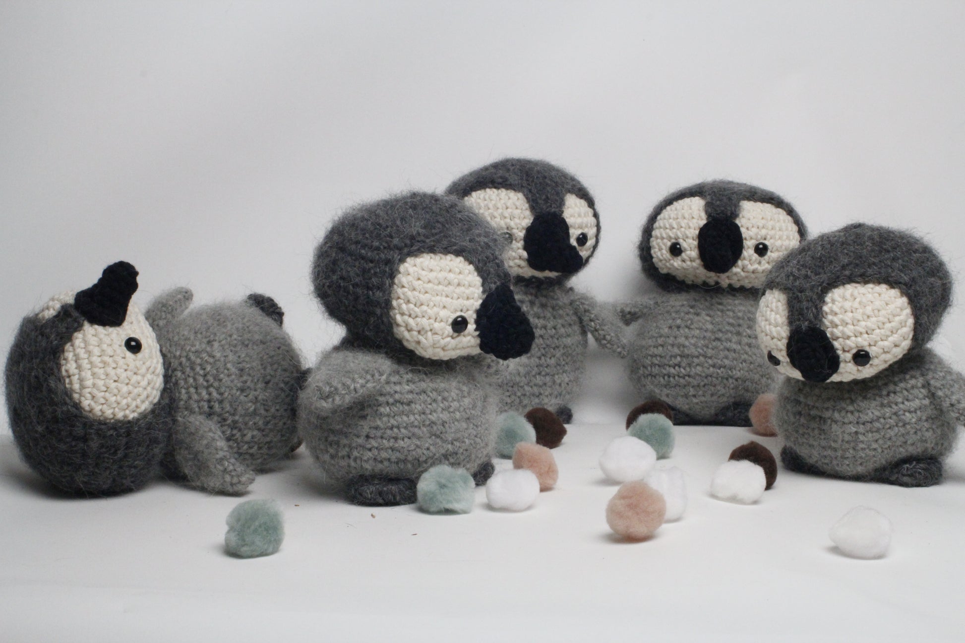 Crocheted penguin toys on a white background