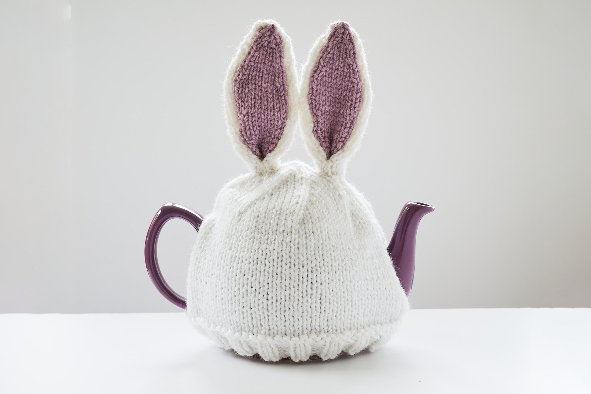 Hand knitted bunny rabbit tea cosy with pom pom bottom.