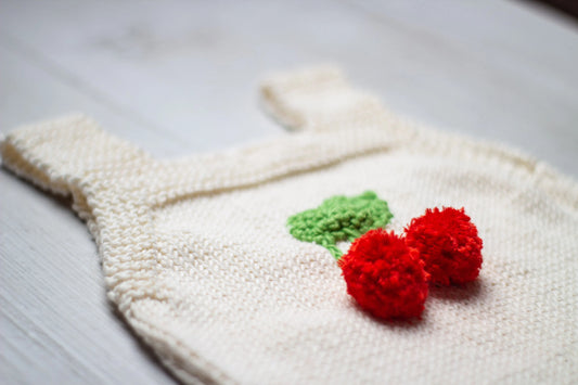 Knitted baby romper with cherries 