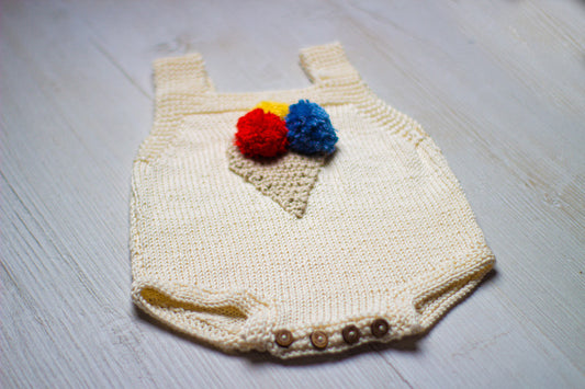 Knitted baby romper with colorful ice cream cone and button flap closure.