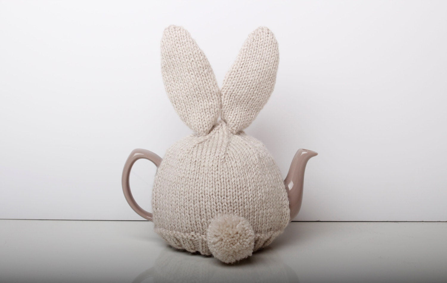 Hand knitted bunny rabbit tea cosy with pom pom bottom. Fits either 6 cup or 2 cup tea pots.