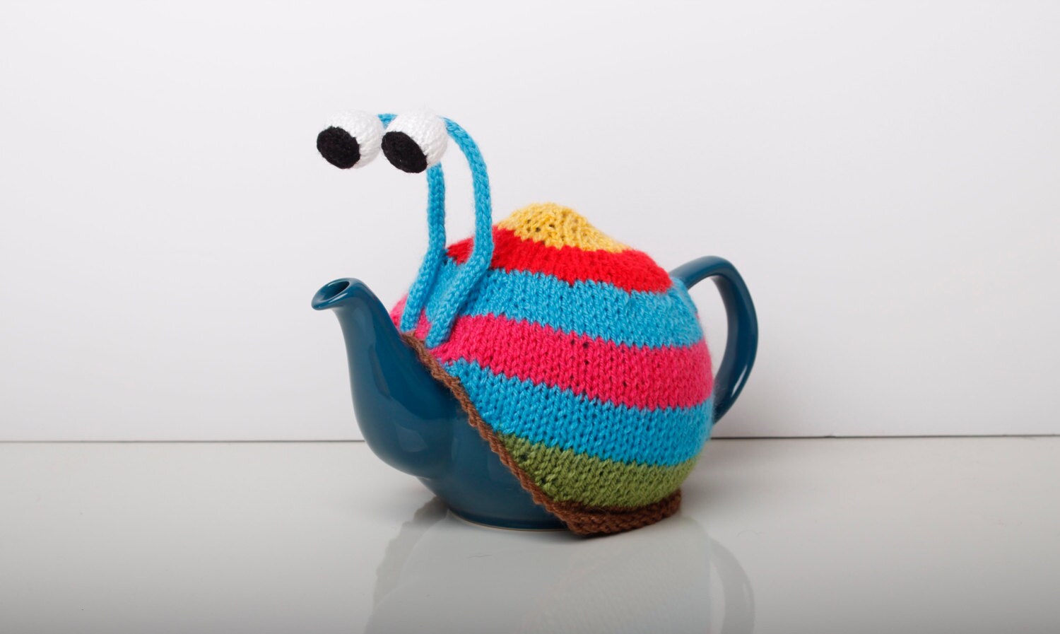 Knitted blue stripy snail tea cosy. Tea lovers teatime treat.