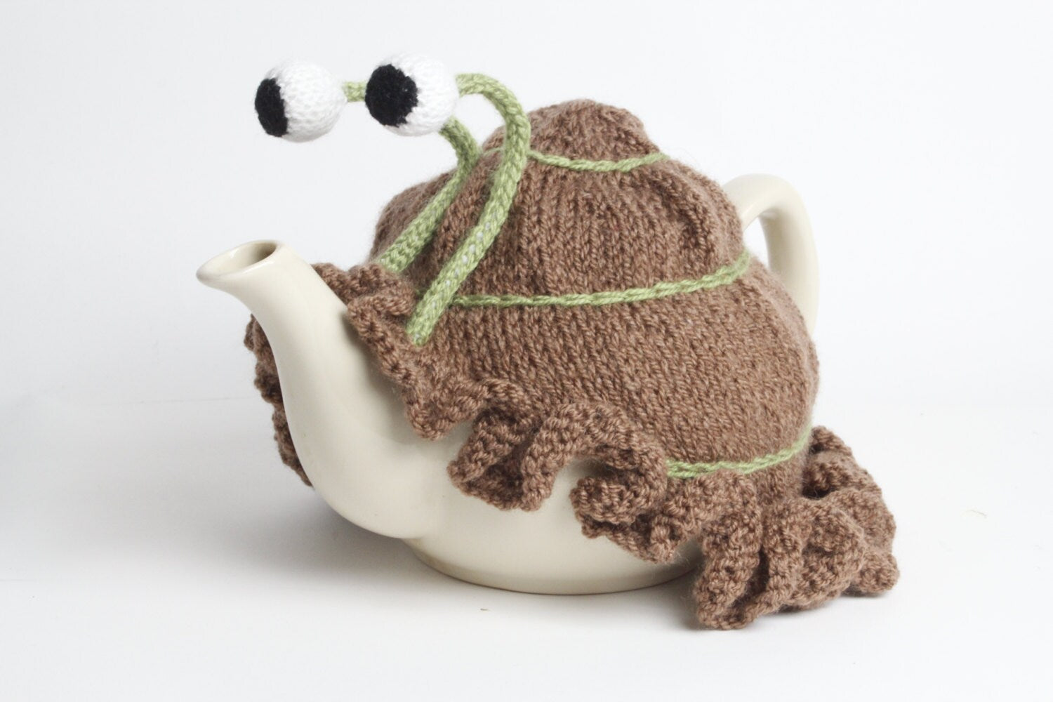 Knitted brown snail tea cosy with frilly bottom. Washable. 2 cup and 6 cup sizes