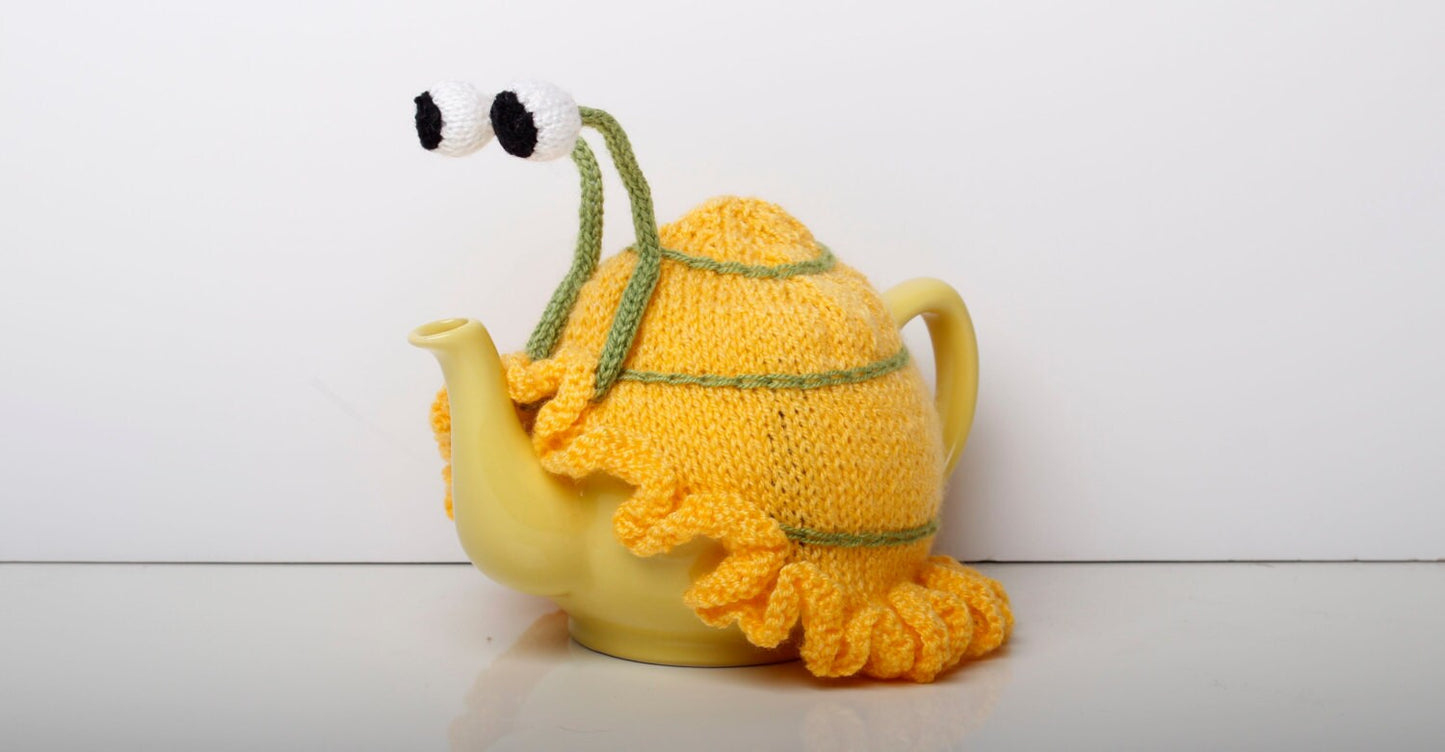 Knitted yellow snail tea cosy with frilly bottom. 6 cup and 2 cup sizes. Washable.