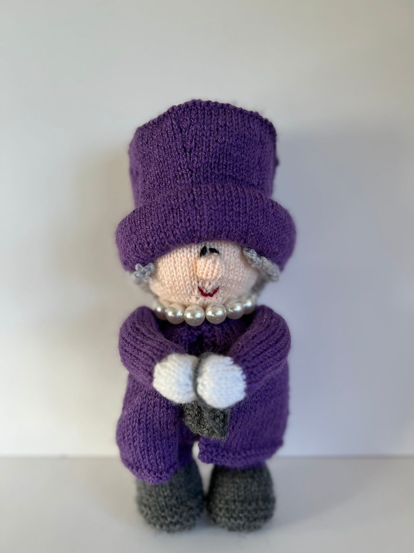 Queen Elizabeth II hand knitted character available in a variety of colours. Handbag on left or right with accessories …