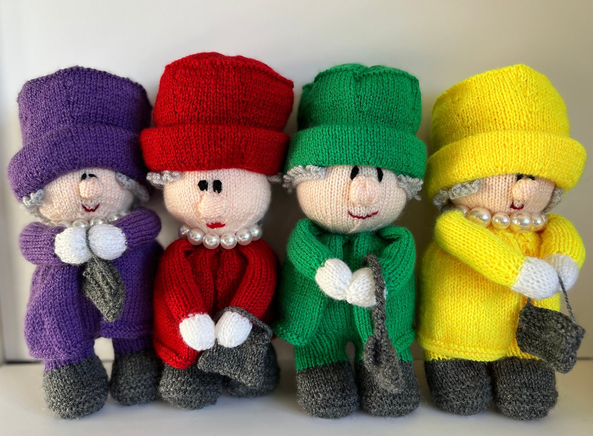 Queen Elizabeth II hand knitted character available in a variety of colours. Handbag on left or right with accessories …