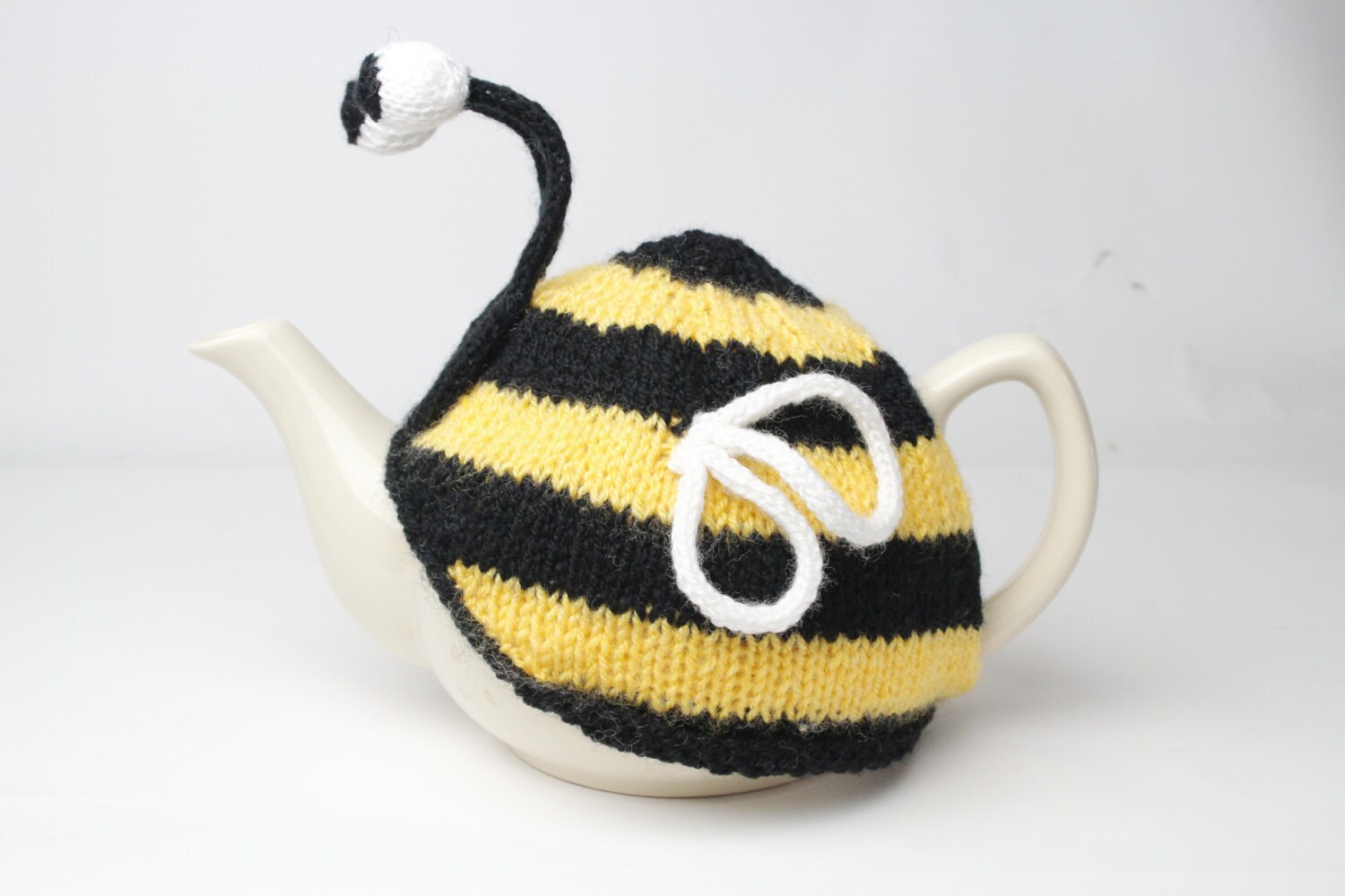 Bumble bee tea cosy. Hand knitted stripy bee cosie in washable yarn.